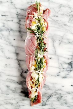 raw fish fillets with herbs and cheese on marble counter top, ready to be served