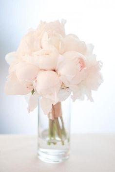 a vase filled with pink flowers sitting on top of a table next to an instagram page