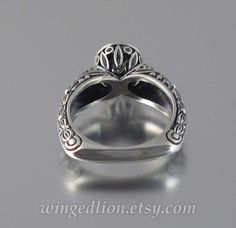 a silver ring with an ornate design on it