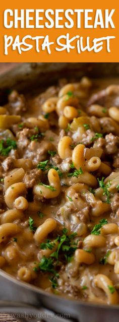 cheesesteak pasta skillet in a pan with parsley on top and text overlay