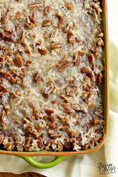 a casserole dish filled with pecans and cheese