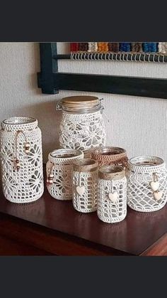 white crocheted jars and baskets on a table