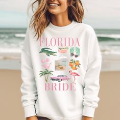 FLORIDA BEACH BRIDES! These Florida beach bachelorette party themed shirts are perfect for any Florida beach Bachelorette Party or Beach Wedding! Available as a tank top or t-shirt. We can change the saying, Florida Bride, Florida Babe, Florida Bach, Florida Bridesmaid Etc. NO RETURNS OR EXCHANGES ON SHIRTS/CLOTHING ITEMS SIZING Please reference our sizing chart in the photos to ensure correct size selection. These tees are unisex crew neck that run true to sizing, not too big and not too small. Bachelorette Party Themed, Beach Bachelorette Party Shirts, Beach Bachelorette Party, Bachelorette Tanks, Bachelorette Party Beach, Beach Bachelorette, Beach Bride, Florida Beach, Bridesmaid Outfit