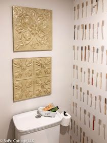 a white toilet sitting next to a wall covered in toothbrushes