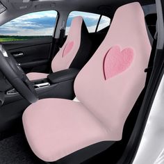 the interior of a car with two pink hearts on it's front seat covers