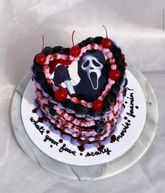 a heart shaped cake decorated with icing and decorations