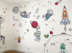 an empty room with several wall decals on the walls and various cartoon characters painted on the walls