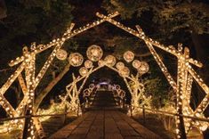 an archway decorated with lights in the night