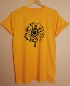 Sunflower ORGANIC tshirt JOIN OUR GREEN REVOLUTION - FASHION DOES NOT HAVE TO POLLUTE THE PLANET *RUNS LARGE - SEE SIZE GUIDE *CLIMATE NEUTRAL MANUFACTURING *SUPER SOFT ORGANIC COTTON *SWEATSHOP FREE - FAIR WAGE FOR WORKERS *MANUFACTURED USING GREEN ENERGY *PRINTED TO ORDER USING WATERBASED INKS AND LOW IMPACT METHODS *1-5 BUSINESS DAYS PROCESSING *30 DAYS RETURNS/EXCHANGES   *Fair Wear Foundation  *FWF *Global Organic Textile Standard (GOTS) *PeTA-approved * Vegan Hand printed to order using extremely low impact methods and eco friendly, solvent free waterbased inks Soft, luxurious feel 1-5 business days processing time Sustainable, ethical and socially responsible manufacturing  Shipped in Paper bags 30 day return/exchange policy Wash at 30 degrees Cotton Crew Neck T-shirt With Sunflower Design, Gift Yellow Graphic Print T-shirt, Yellow Graphic Print T-shirt For Gift, Yellow Graphic Print T-shirt As Gift, Yellow T-shirt With Sunflower Design For Spring, Yellow Plants Print Short Sleeve T-shirt, Yellow Short Sleeve T-shirt With Plant Print, Casual Yellow T-shirt As A Gift, Summer Sunflower Design Short Sleeve T-shirt