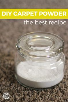 a glass jar filled with white powder sitting on top of a carpeted floor next to a wall