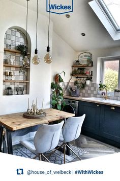 an image of a dining room table and chairs in the middle of a kitchen with skylights