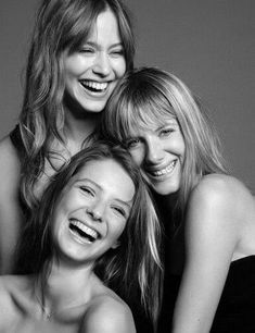 three women are smiling and posing for the camera