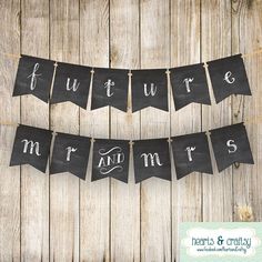 a black banner that says future mrs and mr on it hanging from a wooden fence