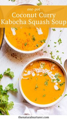 two bowls of coconut curry kabocha squash soup with cilantro on the side