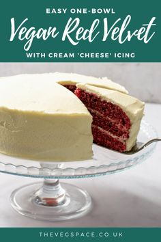 vegan red velvet cake with cream cheese icing is on a glass platter