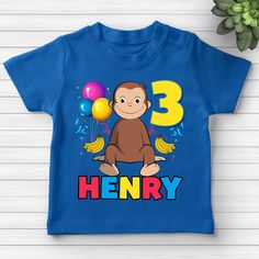 a blue t - shirt with a monkey and balloons on it that says, henry