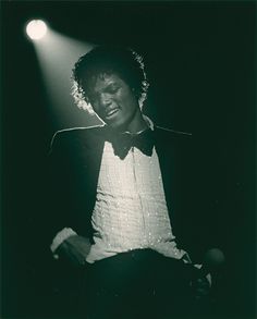 a black and white photo of a man in a tuxedo