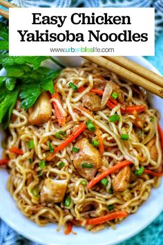 easy chicken yakisob noodles with carrots and green onions in a white bowl