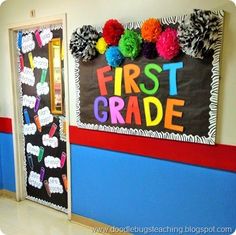 the first grade classroom door is decorated with pom poms and tissue paper flowers