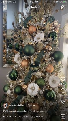 a white christmas tree with green and gold ornaments