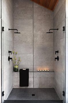 a white tiled shower with candles on the wall