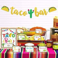 a mexican themed birthday party with taco bar decorations and food on the buffet table