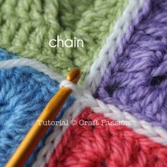 the crochet stitch is being worked on by a knitting needle and yarn ball