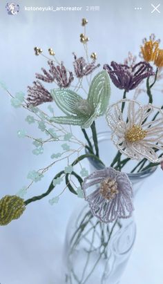 a vase filled with flowers on top of a white table