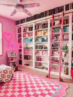 a bedroom with pink walls and lots of bookshelves in the room, along with a checkered rug on the floor