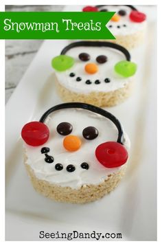 three snowman treats are on a white plate