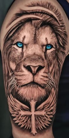 a lion with blue eyes and cross tattoo on the side of his arm is shown