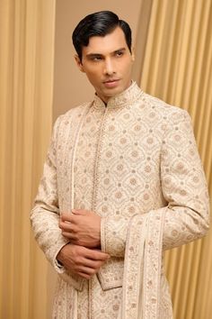 Ivory sherwani, hand embroidered using gold zari and threadwork, accentuated with sequins and French knots. Comes with an embroidered stole, kamarbandh and kurta. Paired with a churidar, safa and jutti fabric. - Aza Fashions Ivory Sherwani, Tarun Tahiliani, French Knots, Churidar, Raw Silk, Aza Fashion, Hand Embroidered, Silk, Fabric