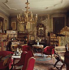 a living room filled with furniture and a chandelier