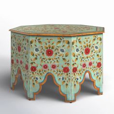 an ornately painted stool with flowers and leaves on the top, sitting in front of a white background