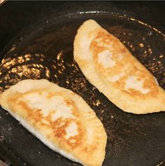 two pieces of food cooking in a frying pan