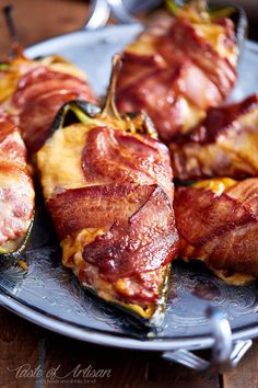 bacon stuffed jalapenos are on a plate