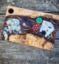 a wooden cutting board with buttons and other items on it sitting on top of a table