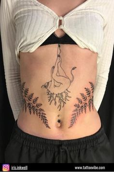 a woman's stomach with tattoos on it