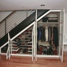 an organized closet under the stairs