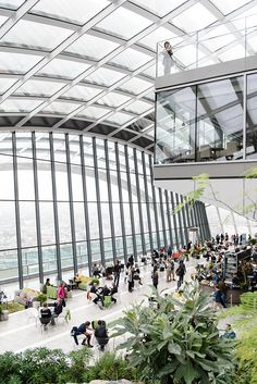 people are standing in the sky garden at the top of the building