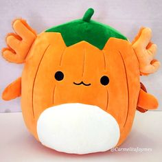 a close up of a stuffed pumpkin on a table