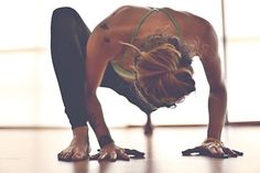 a woman doing a handstand on the floor