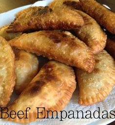 some fried empanadas on a white plate with the words beef empanadas