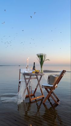 two chairs and a table in the water