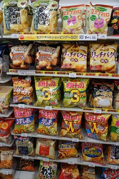 an assortment of japanese snacks on display in a grocery store's deli shelf