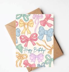 a card with bows on it that says happy birthday in blue, pink, yellow and green