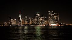 the city skyline is lit up at night