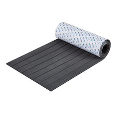 a yoga mat with a blue and white polka dot design on the top, rolled up