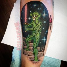 a green skeleton sitting on top of a step with a candle in it's hand