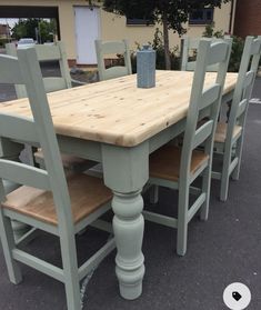 a wooden table with six chairs around it